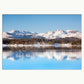 Stunning winter landscape showing snow capped mountains and a perfect reflection in Lake Windermere, lake District. Shown with a white mount