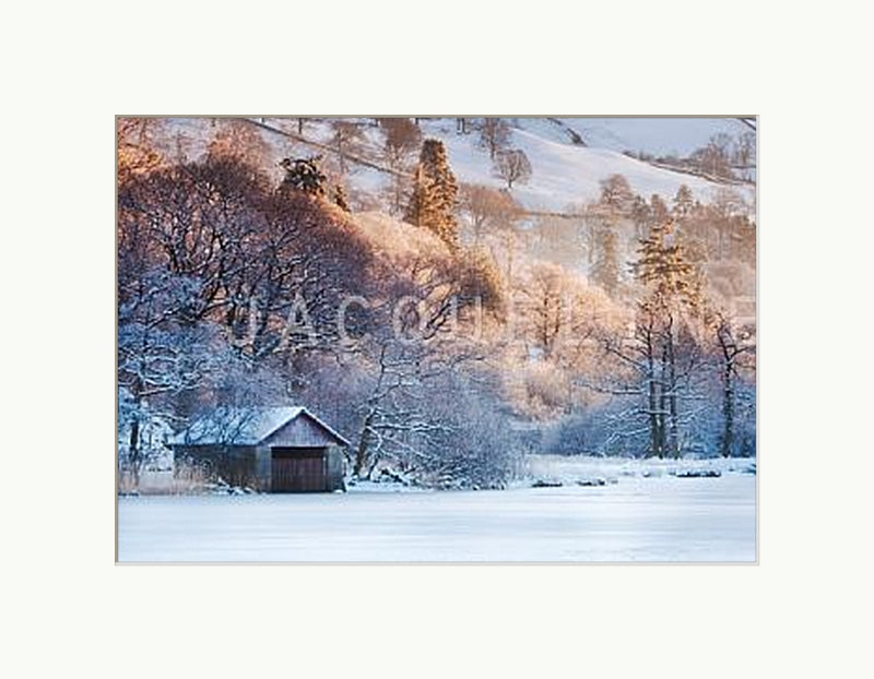 Stunning winter photograph of a frozen lake and snow capped fells at Rydal Water, Lake District,. Shown with a white mount