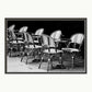 A black and white photograph of cafe table and chairs in the Quartier Latin district in Paris. Shown with a double mount of black on the bottom and white on top.